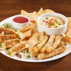Starting 3 Sampler, potstickers, mozzarella sticks, chips and queso