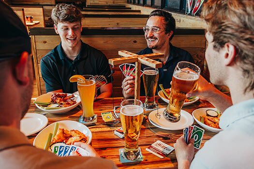 guys at miller's ale house playing a bar game